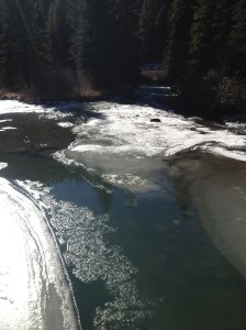 Crossing over the beautiful river with its ice and flow.